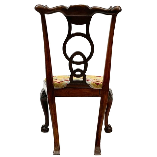 613 - A George III mahogany dining chair. With an unusual circle and oval moulded back, and raised on cabr... 