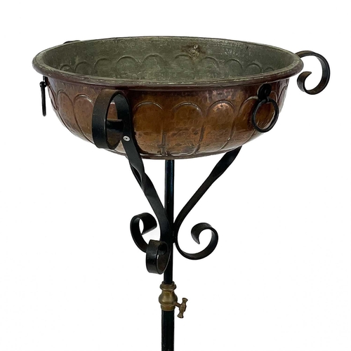 617 - A late Victorian wrought iron adjustable lamp stand. Now fitted as a torchere, with embossed copper ... 