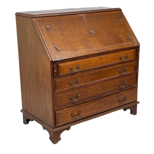 622 - An early 20th century oak bureau. The writing slope opens to reveal an arrangement of drawers and pi... 