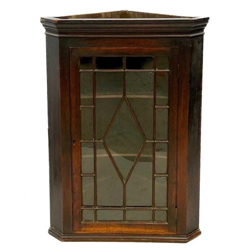 629 - A George III oak glazed hanging corner cupboard. Fitted astragal glazing bars, height 105cm, width 7... 