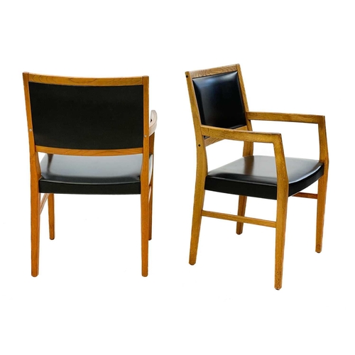 635 - A pair of mid century Svegards Markaryd teak and vinyl armchairs Makers stamp to underside, height 8... 