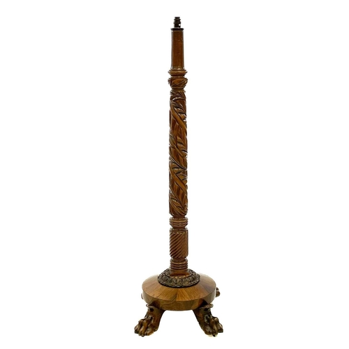 641 - A 19th century carved mahogany and rosewood standard lamp. With leaf carved column, on a circular ba... 