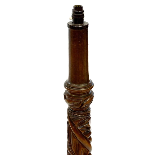 641 - A 19th century carved mahogany and rosewood standard lamp. With leaf carved column, on a circular ba... 