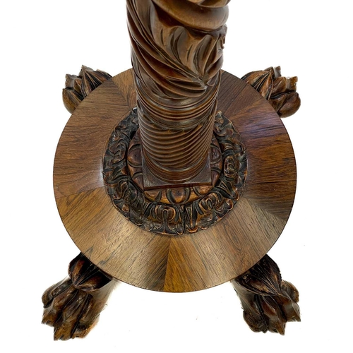 641 - A 19th century carved mahogany and rosewood standard lamp. With leaf carved column, on a circular ba... 