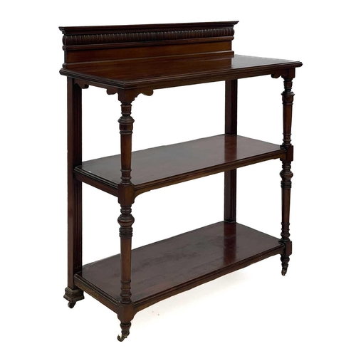 651 - A late Victorian walnut three tier buffet. With a raised back and raised on turned front supports, h... 