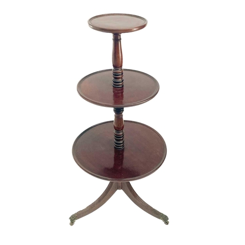 655 - A Regency mahogany three tier circular dumb waiter. With a turned central column on swept tripod sup... 