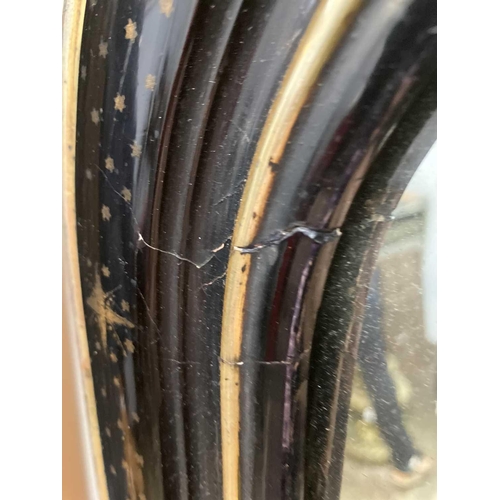 659 - A Victorian ebonised and gilt arched overmantel mirror. The broad moulded frame with star and polka ... 