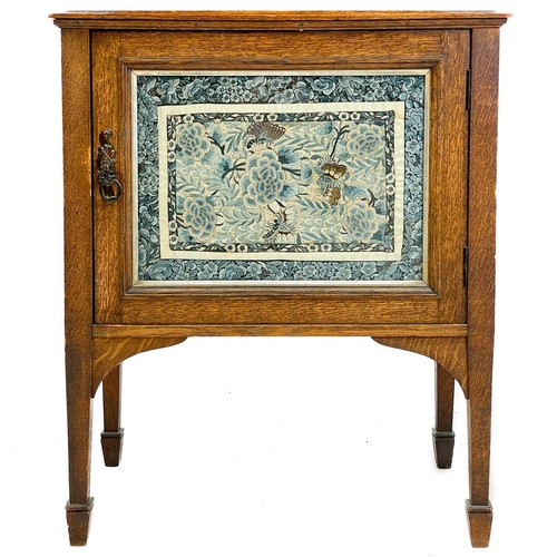 661 - An Arts and Crafts oak dresser, of diminutive size. The rack with shaped sides and glazed silk panel... 