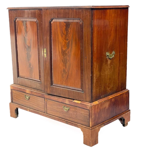 668 - A 19th century mahogany linen press. The upper section with twin cupboard door enclosing three adjus... 