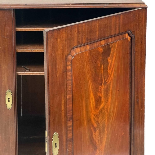 668 - A 19th century mahogany linen press. The upper section with twin cupboard door enclosing three adjus... 