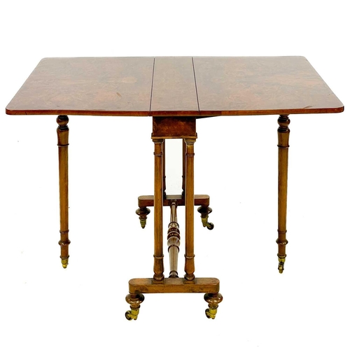 672 - A Victorian figured walnut Sutherland table. With turned supports and stretcher, on brass castors, h... 