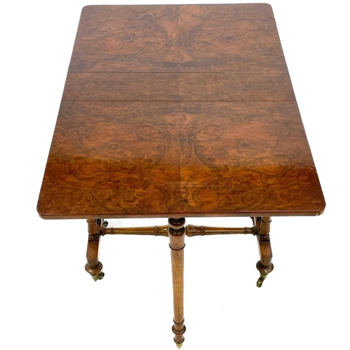 672 - A Victorian figured walnut Sutherland table. With turned supports and stretcher, on brass castors, h... 