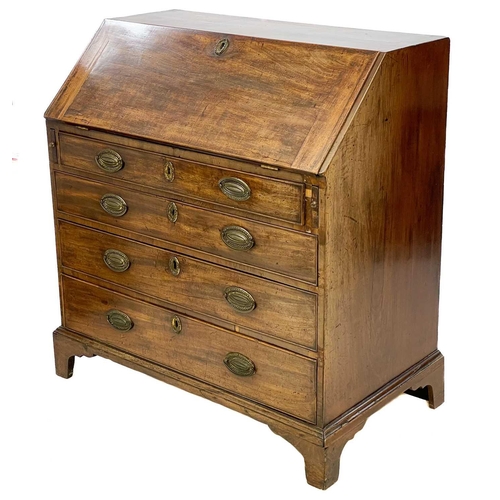 679 - A George III mahogany bureau. The fall front enclosing drawers and pigeonholes, with four graduated ... 