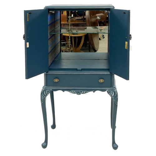 688 - A blue painted cocktail cabinet. Second half 20th century, fitted with two doors enclosing a lined a... 