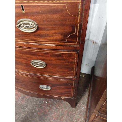 696 - A late George III mahogany and chequer strung bow front chest. Fitted two short and two long drawers... 