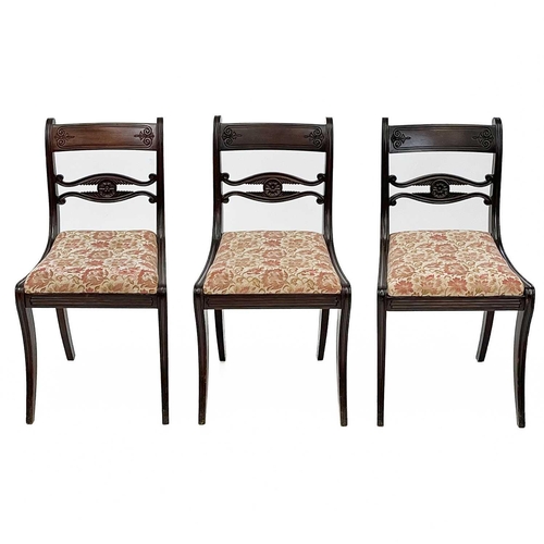 703 - A set of five Regency mahogany dining chairs. With carved mid-rails on sabre front legs, together wi... 