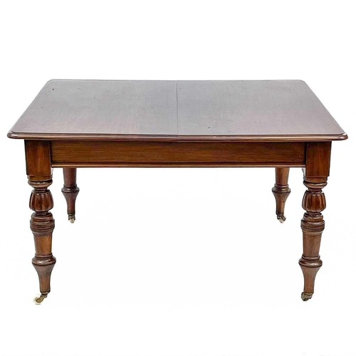 705 - A Victorian mahogany extending dining. With two additional leaves. raised on turned and fluted legs ... 