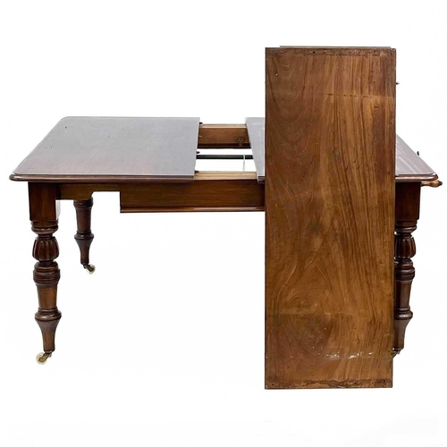 705 - A Victorian mahogany extending dining. With two additional leaves. raised on turned and fluted legs ... 