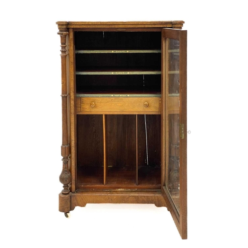 723 - A Victorian walnut and inlaid music cabinet. With a single glazed door enclosing a drawer, shelves a... 