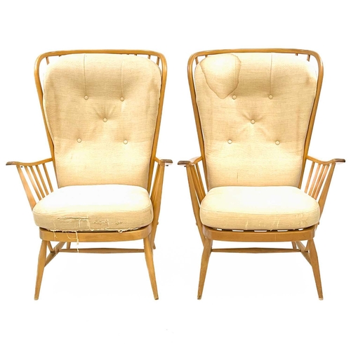 724 - An Ercol light elm and beech three-piece cottage suite. With stick backs and turned legs, loose cush... 