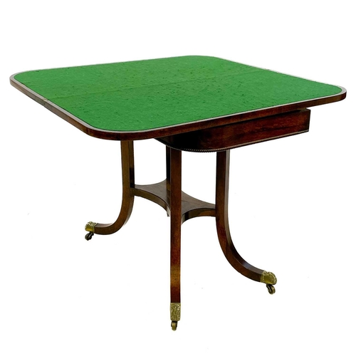 736 - A Regency rosewood fold-top card table. The frieze with a beaded edge, raised on four brass capped o... 