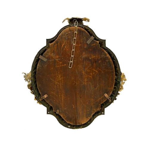 737 - A substantial gilt bronze wall mirror. Probably French, 19th century, the cartouche shape frame with... 