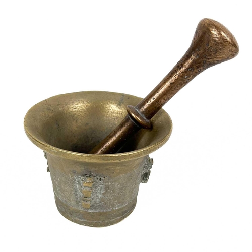 74 - A brass mortar and pestle. Together with a Dutch brass hinged box with lion mask handles and a small... 