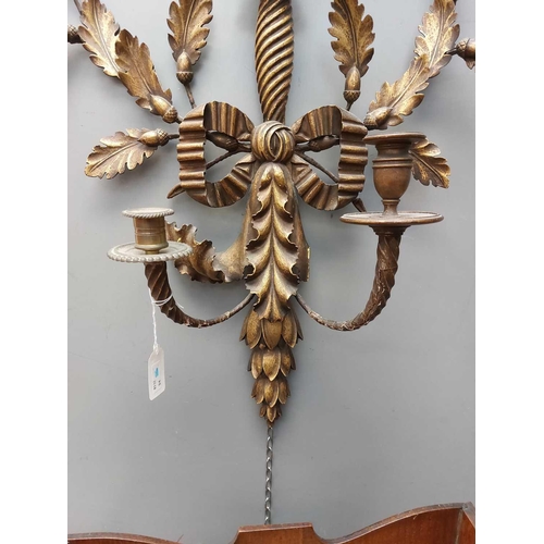 742 - An Empire style gilt wood and gesso girandole. 19th century, with eagle crest above two oak leaf and... 