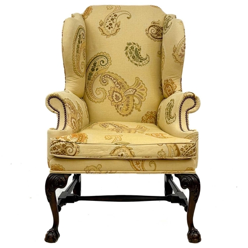 749 - A good George II style walnut carved upholstered wing back armchair. Raised on front cabriole legs c... 