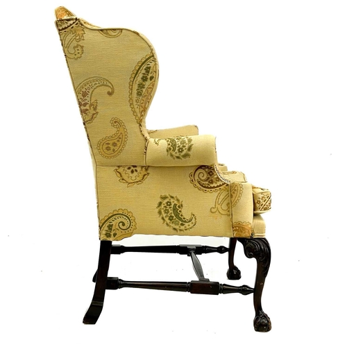 749 - A good George II style walnut carved upholstered wing back armchair. Raised on front cabriole legs c... 