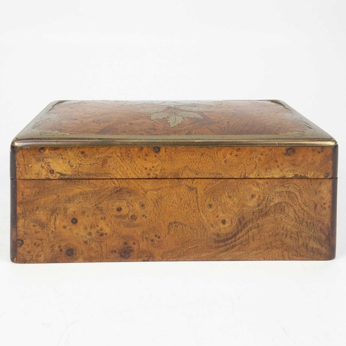 85 - A Continental elm and brass inlaid trinket box. With etched floral and foliate inlaid lid, width 16c... 