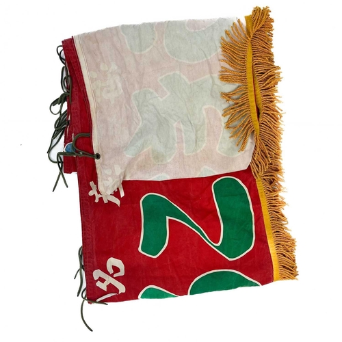 95 - A Japanese banner. Red, with gold tassels, approximately six meters in length.