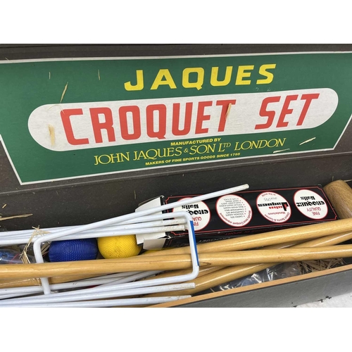 96 - A Jaques lawn croquet set In box. There are four mallets, and four balls, The mallet heads have not ... 