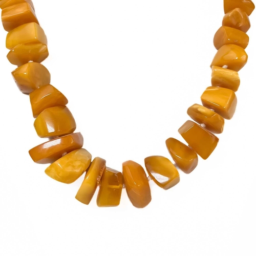 409 - A butterscotch 'amber' irregular beaded necklace. 117.9g. Approximately 38cm in length.