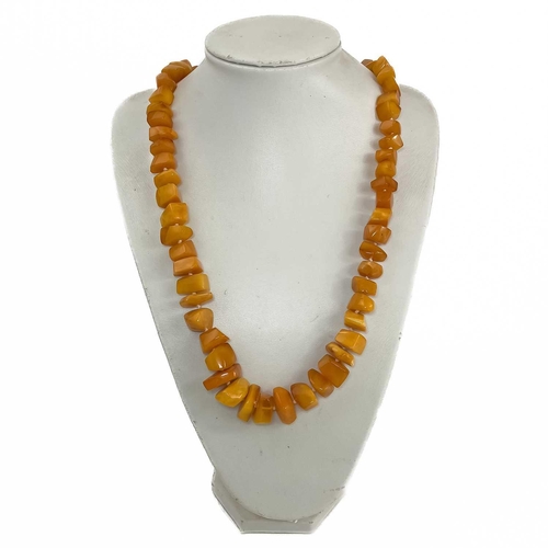 409 - A butterscotch 'amber' irregular beaded necklace. 117.9g. Approximately 38cm in length.