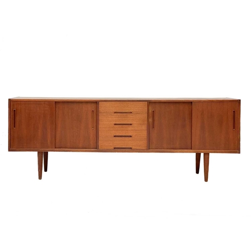 10 - A Nils Jonsson Troeds teak sideboard Fitted a central bank of four drawers, flanked by two cupboards... 