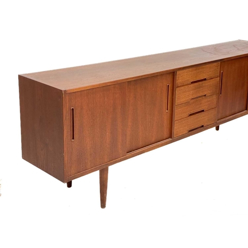 10 - A Nils Jonsson Troeds teak sideboard Fitted a central bank of four drawers, flanked by two cupboards... 