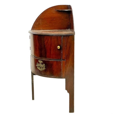 100 - A George III mahogany corner washstand. With later inset leather skiver above a single cupboard door... 