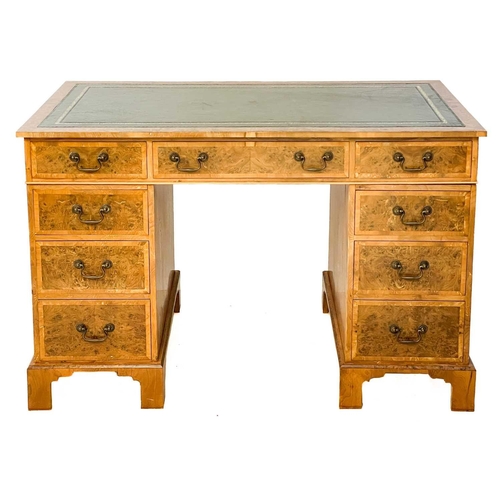 105 - A 20th century figured yew pedestal desk by Abbey Reproductions, Penzance. With a green tooled leath... 