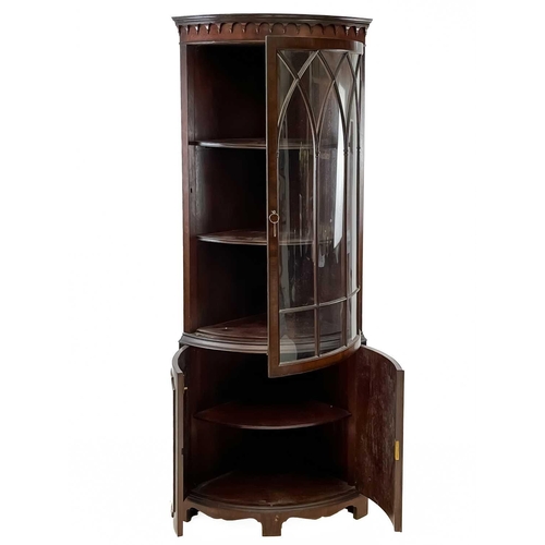 108 - A George III style mahogany floor standing corner cabinet. The upper part with a moulded arcaded fri... 