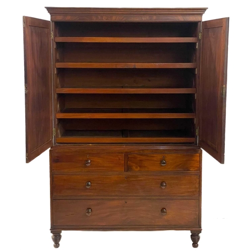 116 - An early Victorian mahogany linen press. With two plain panelled doors enclosing five sliding shelve... 