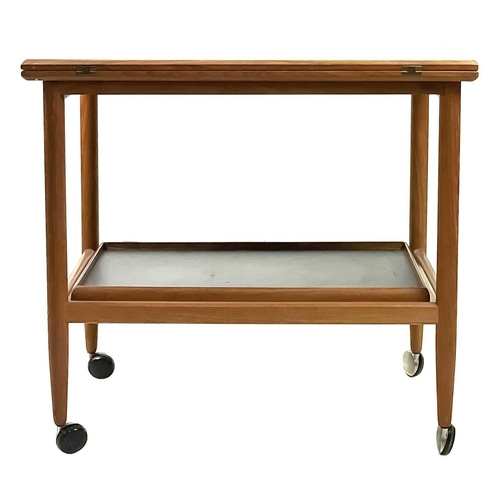 12 - A mid century teak swivel fold over trolley probably by Arrebo Møblor With a removable tray on turne... 