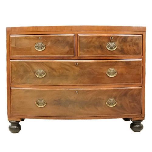 15 - A 19th century mahogany bow front chest of drawers. With two short and two long drawers raised on ba... 