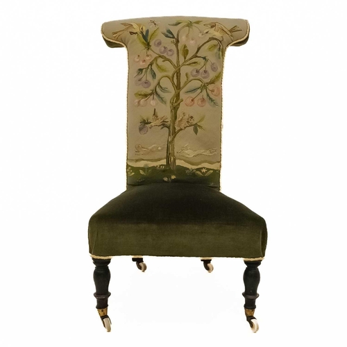 22 - A Victorian walnut framed prie dieu chair. The back embroidered with birds and animals in a tree, on... 