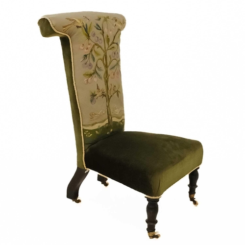 22 - A Victorian walnut framed prie dieu chair. The back embroidered with birds and animals in a tree, on... 