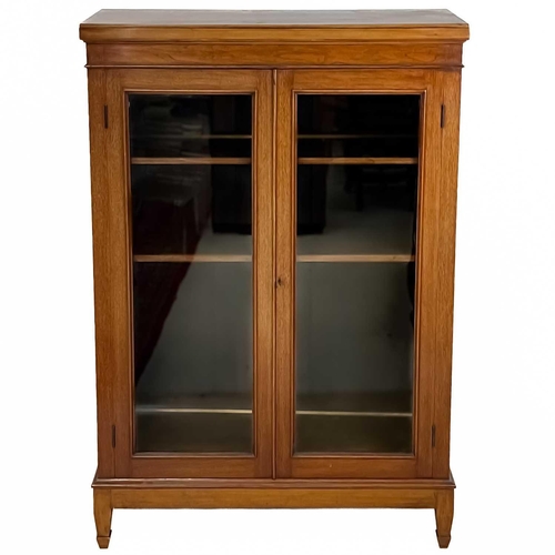 27 - A late Victorian mahogany glazed low bookcase. The twin glazed doors encloses three adjustable shelv... 