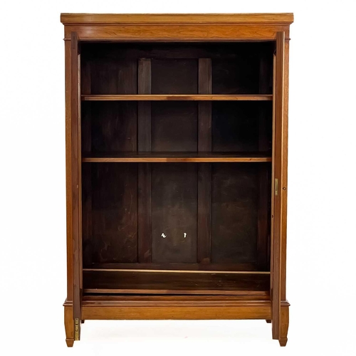 27 - A late Victorian mahogany glazed low bookcase. The twin glazed doors encloses three adjustable shelv... 