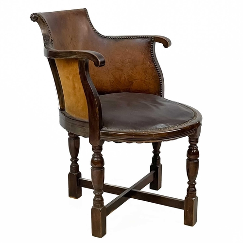 31 - A Victorian walnut and leather elbow chair. On turned supports, height 75.5cm width 47cm depth 65cm.