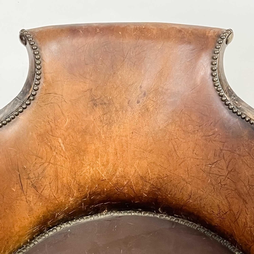 31 - A Victorian walnut and leather elbow chair. On turned supports, height 75.5cm width 47cm depth 65cm.