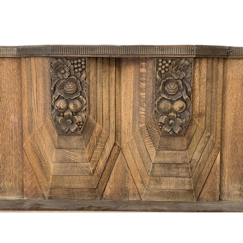 34 - An Art Deco French walnut carved fire surround. Decorated with fruits, flowers and geometric designs... 